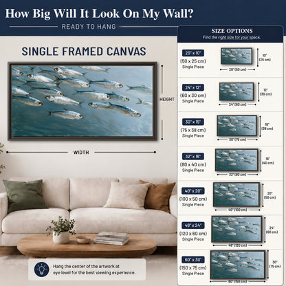 A school of silver fish moving together through cool blue water single framed canvas wall art size guide above a sofa; room view is illustrative