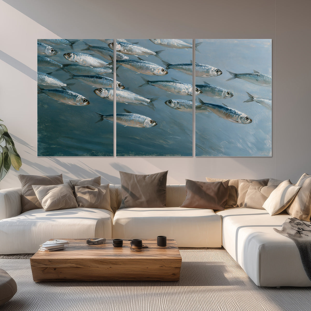 A school of silver fish moving together through cool blue water set of 3 poster prints displayed in a living room