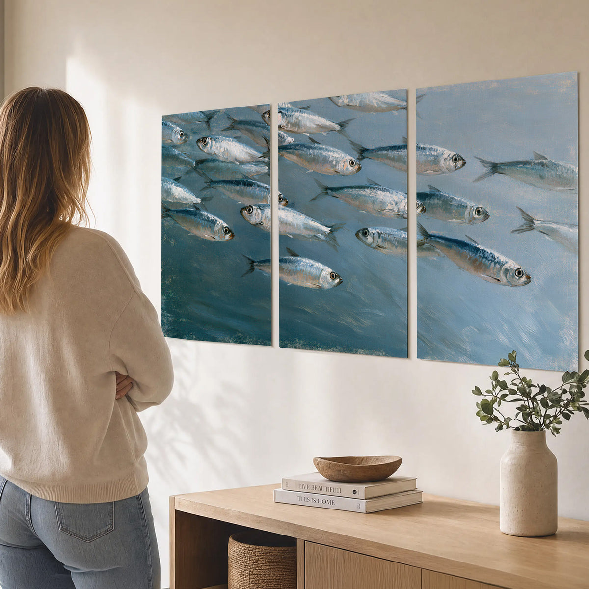 A school of silver fish moving together through cool blue water set of 3 poster prints three panel arrangement on a wall