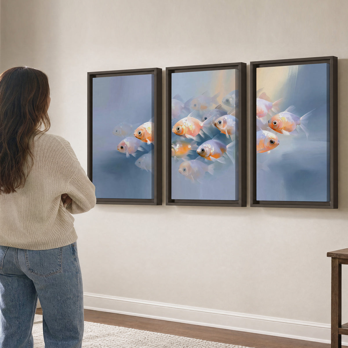 Rounded peach and gold fish floating in a softly lit blue underwater scene 3 piece framed canvas wall art three panel arrangement on a wall
