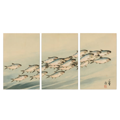 A flowing school of small fish above pale blue water on a cream ground 3 piece canvas wall art viewed straight on