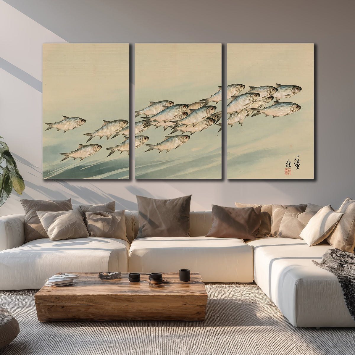 A flowing school of small fish above pale blue water on a cream ground 3 piece canvas wall art displayed in a living room