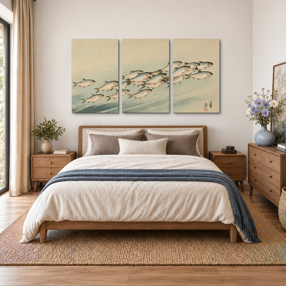 A flowing school of small fish above pale blue water on a cream ground 3 piece canvas wall art styled in an interior
