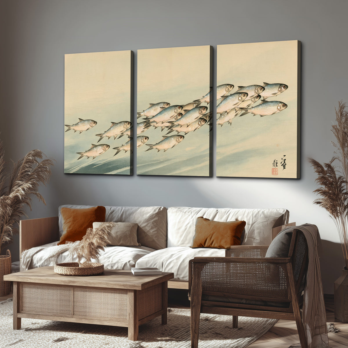 A flowing school of small fish above pale blue water on a cream ground 3 piece canvas wall art displayed in a rustic living room