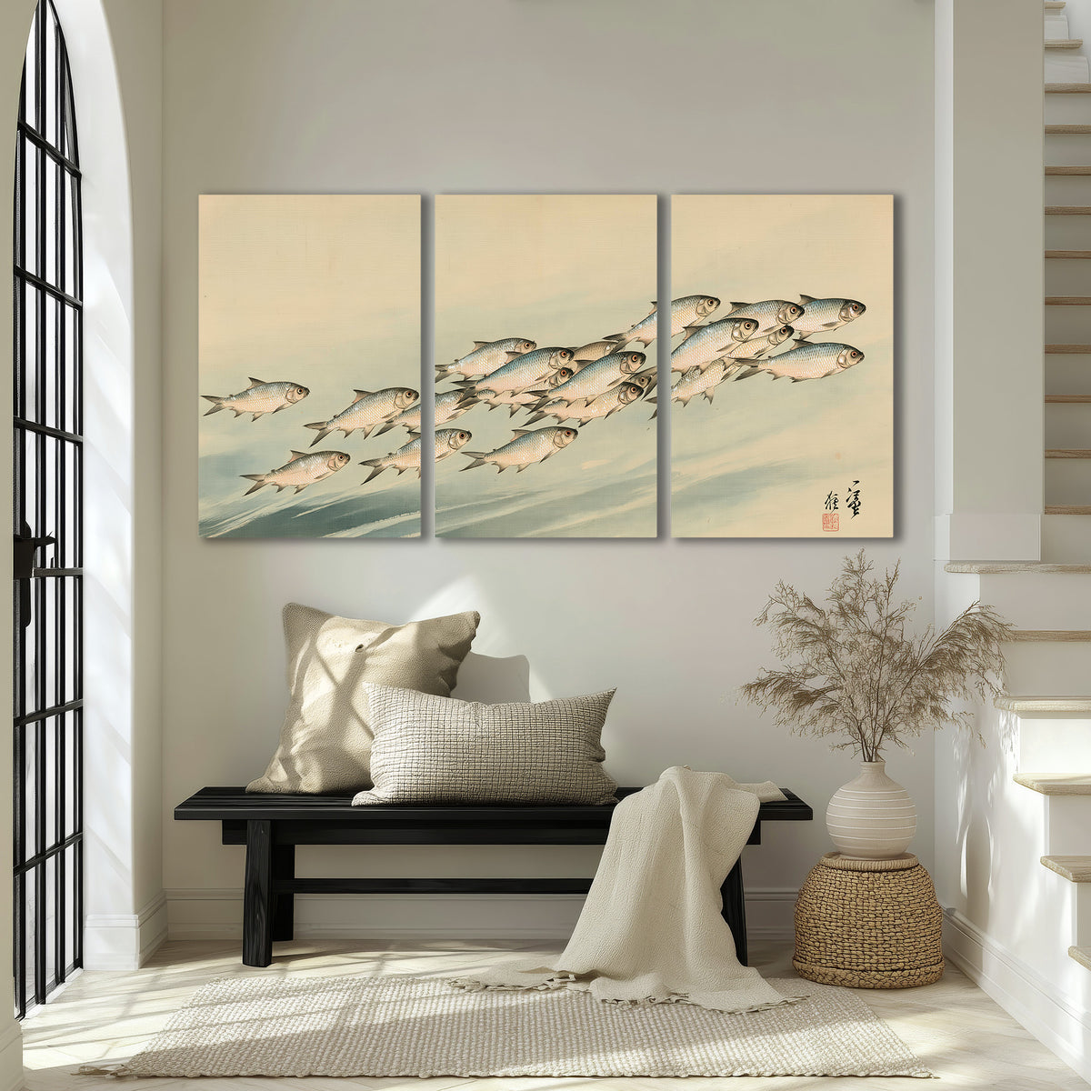 A flowing school of small fish above pale blue water on a cream ground 3 piece canvas wall art displayed in a entryway