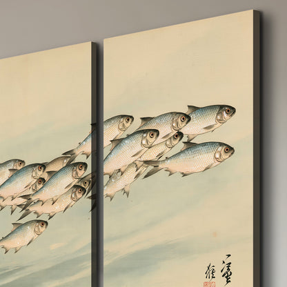 A flowing school of small fish above pale blue water on a cream ground 3 piece canvas wall art room and product view