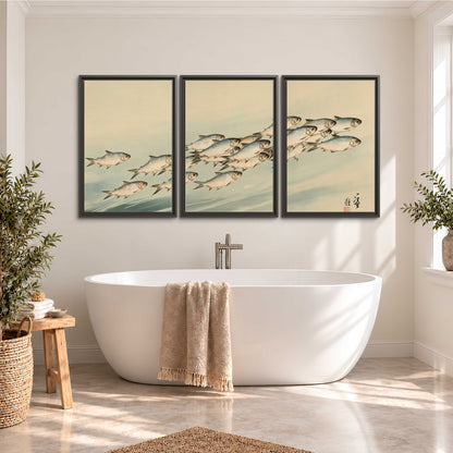 A flowing school of small fish above pale blue water on a cream ground 3 piece framed canvas wall art styled in an interior