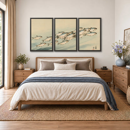 A flowing school of small fish above pale blue water on a cream ground 3 piece framed canvas wall art styled in an interior