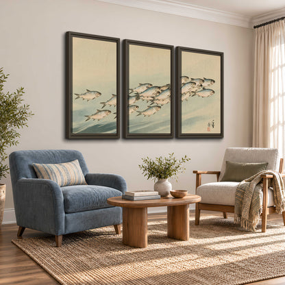 A flowing school of small fish above pale blue water on a cream ground 3 piece framed canvas wall art styled in an interior