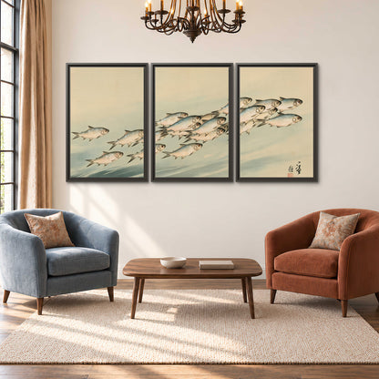 A flowing school of small fish above pale blue water on a cream ground 3 piece framed canvas wall art styled in an interior