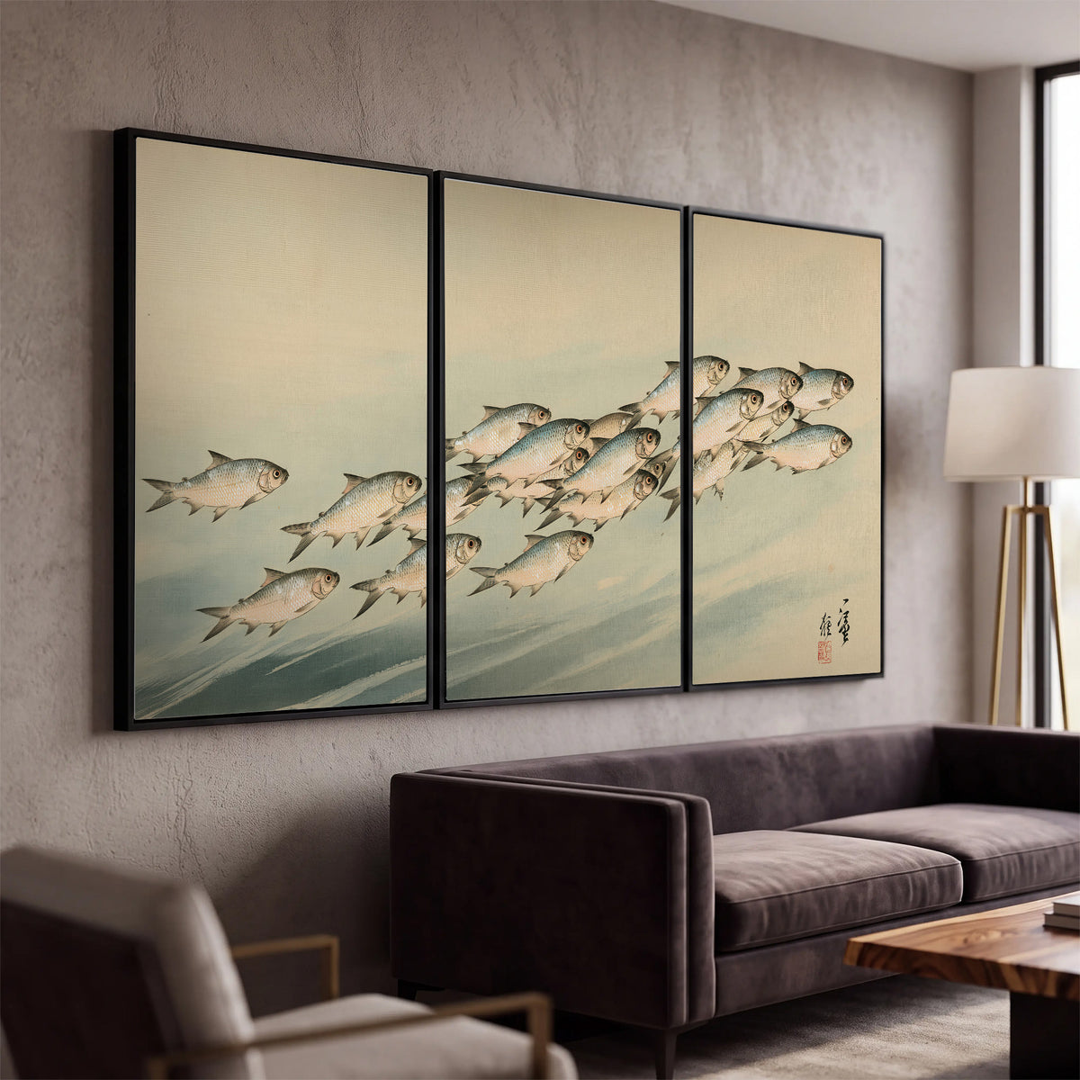 A flowing school of small fish above pale blue water on a cream ground 3 piece framed canvas wall art displayed in a modern living room