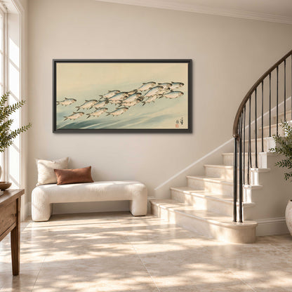 A flowing school of small fish above pale blue water on a cream ground single framed canvas wall art styled in an interior
