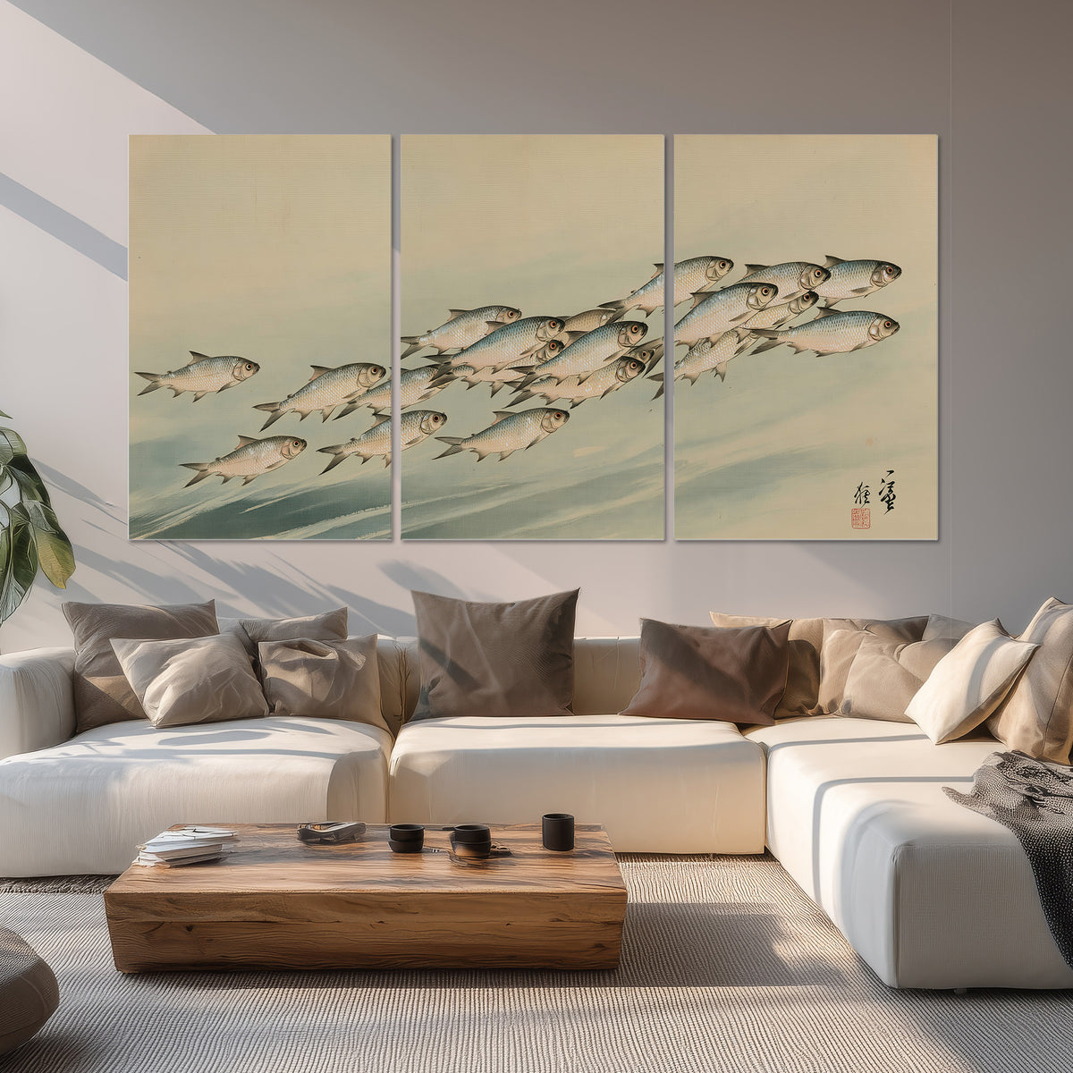 A flowing school of small fish above pale blue water on a cream ground set of 3 poster prints displayed in a living room