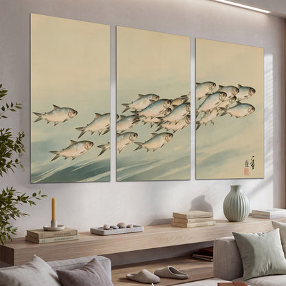 A flowing school of small fish above pale blue water on a cream ground set of 3 poster prints displayed in a console