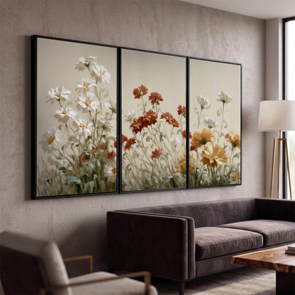 Loose ivory, rust and golden wildflowers on a soft neutral background 3 piece framed canvas wall art displayed in a modern living room