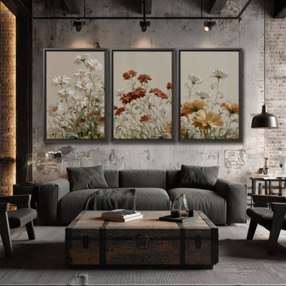 Loose ivory, rust and golden wildflowers on a soft neutral background 3 piece framed canvas wall art displayed in a industrial room
