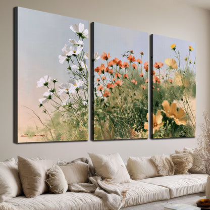 White and orange meadow flowers with fine green stems under a pale sky 3 piece canvas wall art room and product view