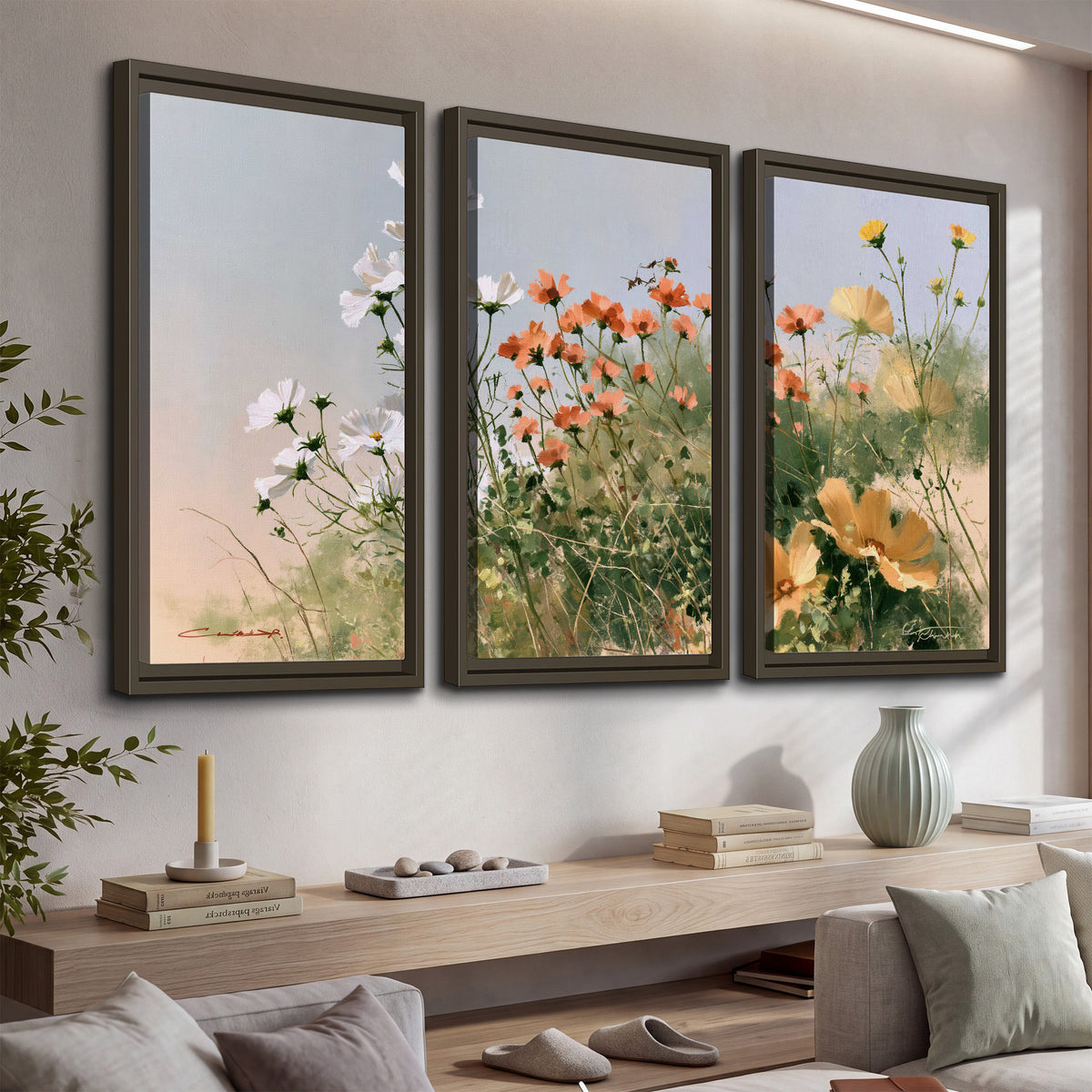 White and orange meadow flowers with fine green stems under a pale sky 3 piece framed canvas wall art displayed in a console