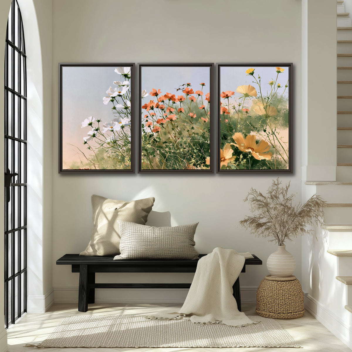 White and orange meadow flowers with fine green stems under a pale sky 3 piece framed canvas wall art displayed in a entryway