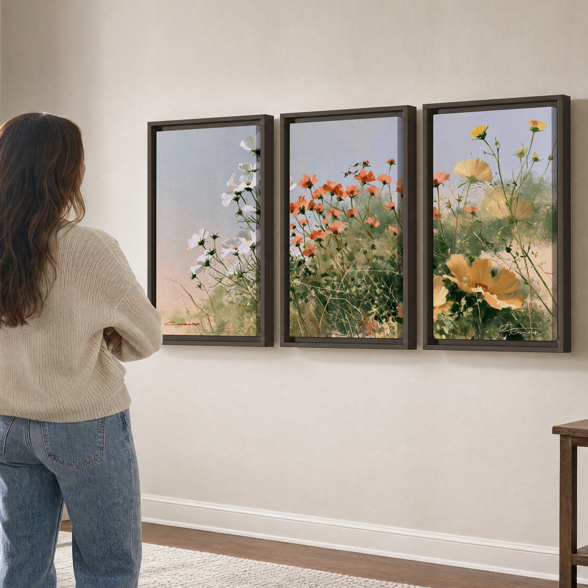 White and orange meadow flowers with fine green stems under a pale sky 3 piece framed canvas wall art three panel arrangement on a wall