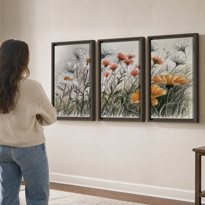 Fine dark stems and white daisies with warm orange accents in a delicate botanical composition 3 piece framed canvas wall art three panel arrangement on a wall