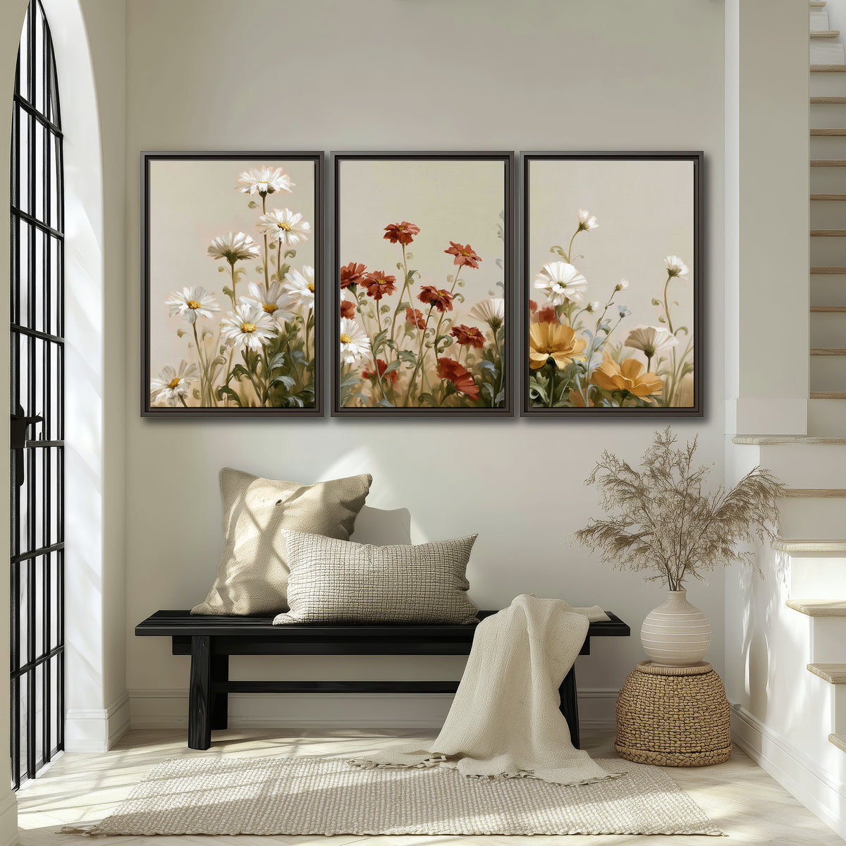 White wildflowers and warm red blossoms rising against a soft beige background 3 piece framed canvas wall art displayed in a entryway