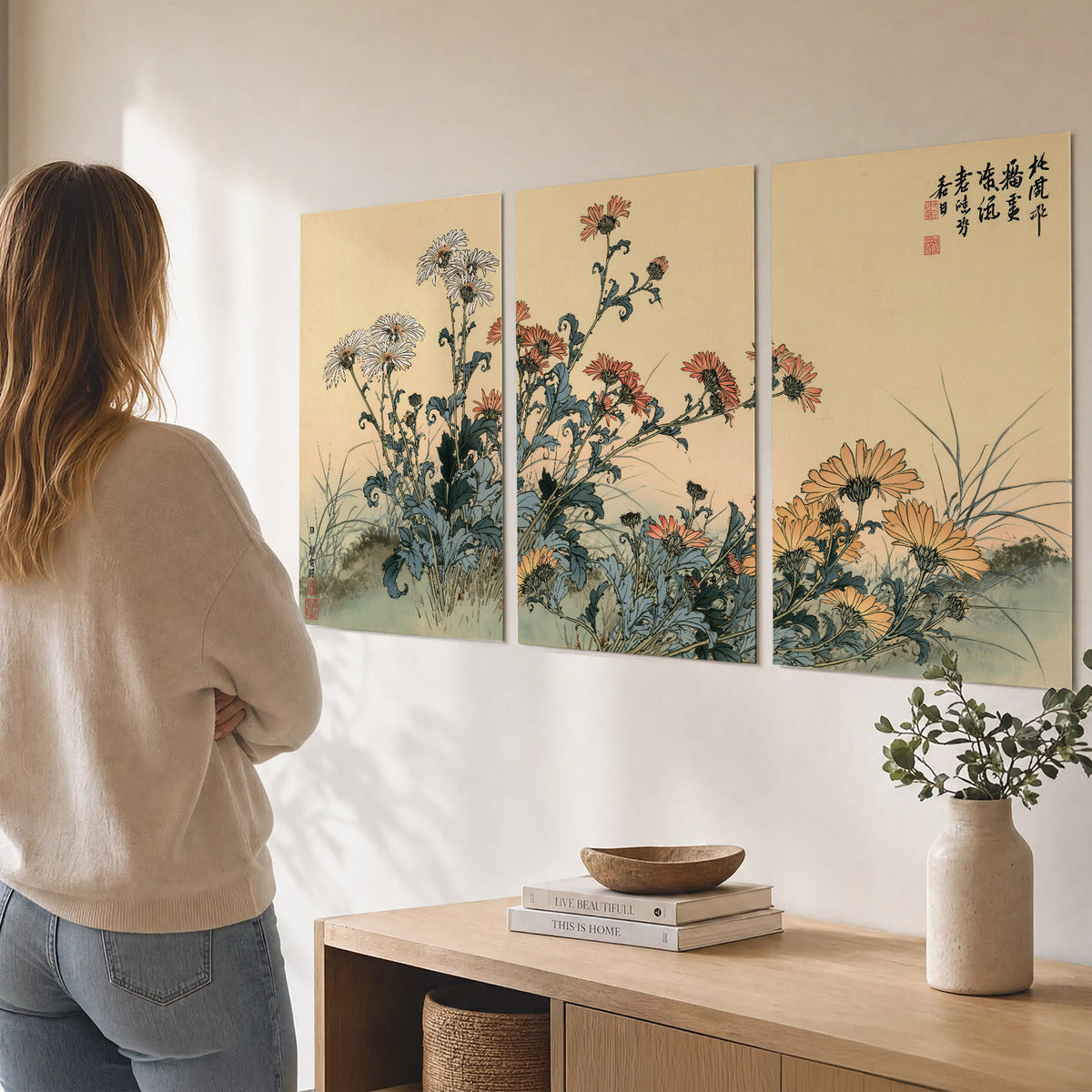 Flowering plants and a butterfly arranged on a warm cream ground with decorative script set of 3 poster prints three panel arrangement on a wall