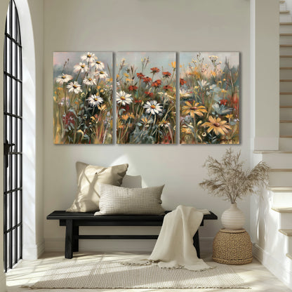 White daisies, rust blooms and long grasses in a softly shadowed meadow 3 piece canvas wall art displayed in a entryway