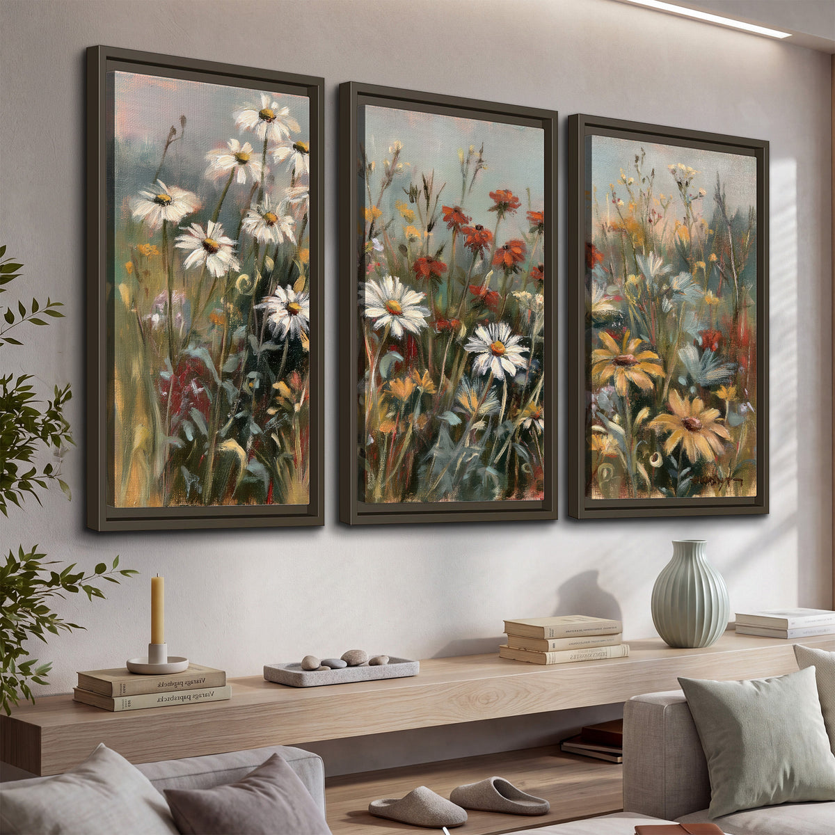 White daisies, rust blooms and long grasses in a softly shadowed meadow 3 piece framed canvas wall art displayed in a console