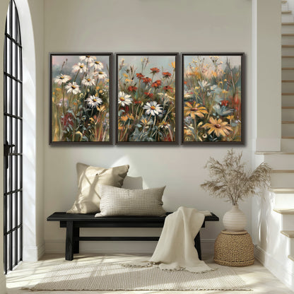 White daisies, rust blooms and long grasses in a softly shadowed meadow 3 piece framed canvas wall art displayed in a entryway