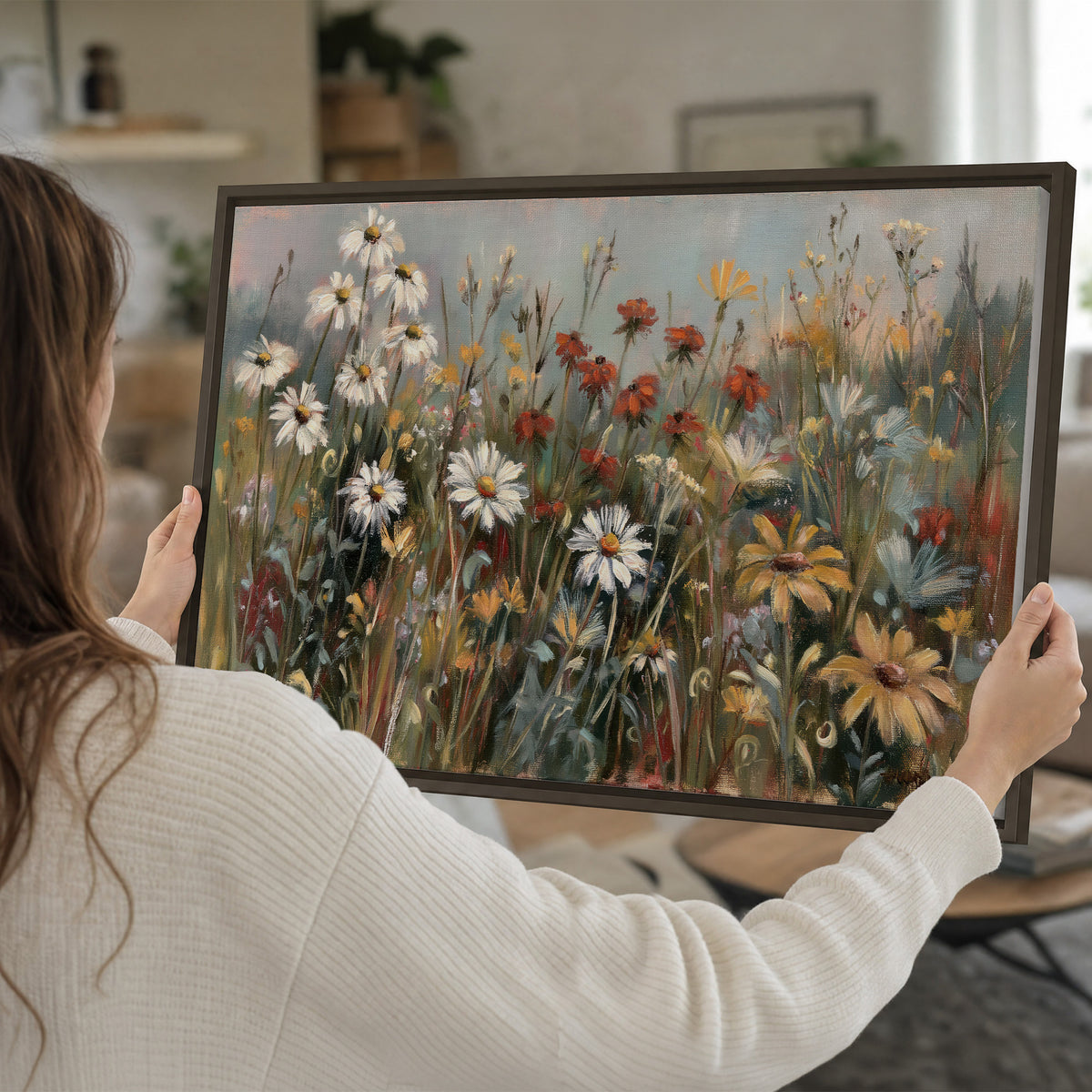 White daisies, rust blooms and long grasses in a softly shadowed meadow single framed canvas wall art held in hands