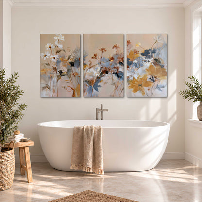 Loose blue and ochre blossoms layered across a warm neutral background 3 piece canvas wall art styled in an interior