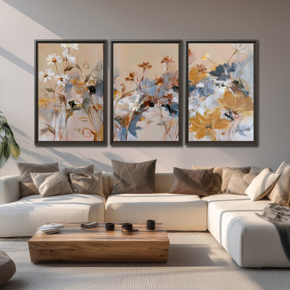Loose blue and ochre blossoms layered across a warm neutral background 3 piece framed canvas wall art displayed in a living room