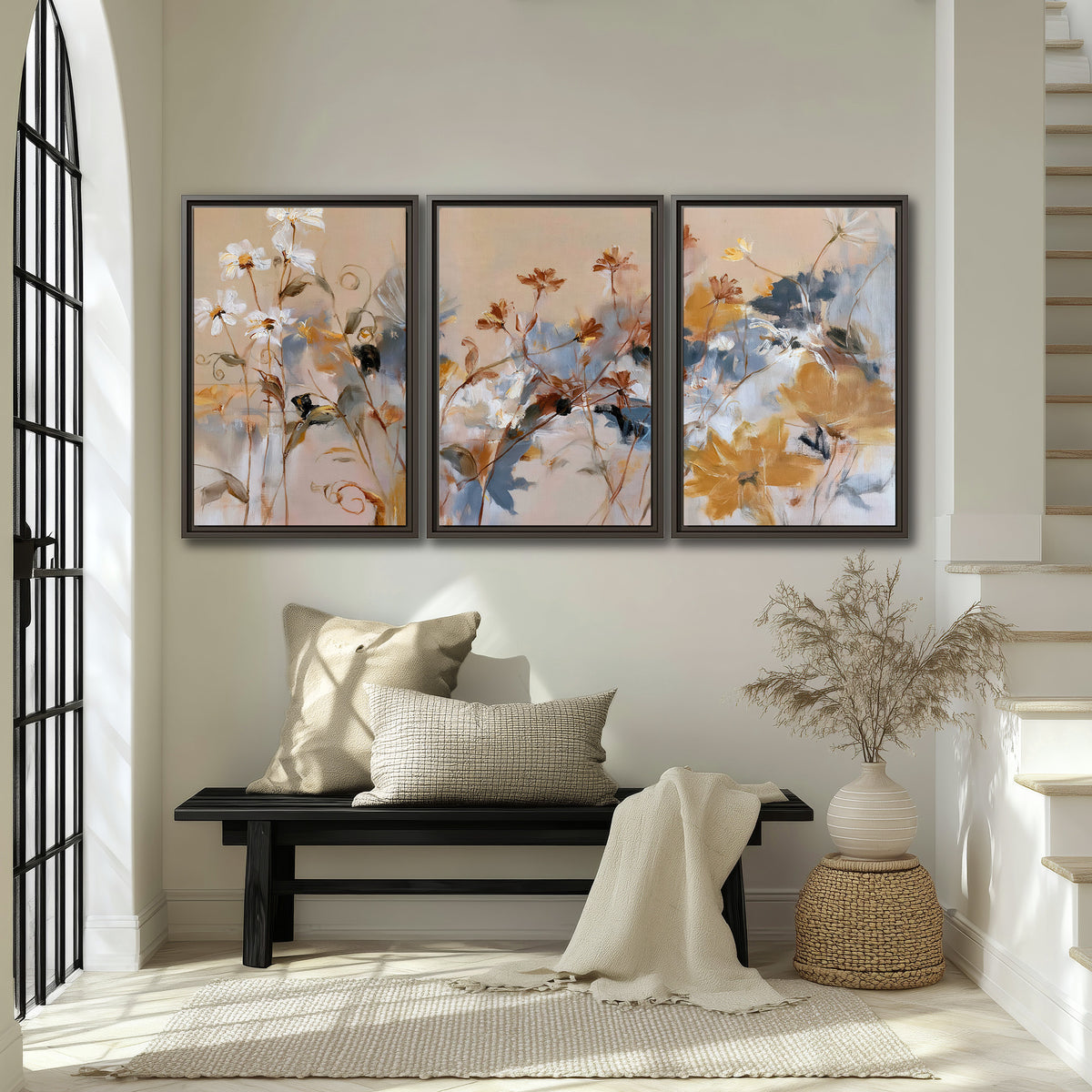 Loose blue and ochre blossoms layered across a warm neutral background 3 piece framed canvas wall art displayed in a entryway