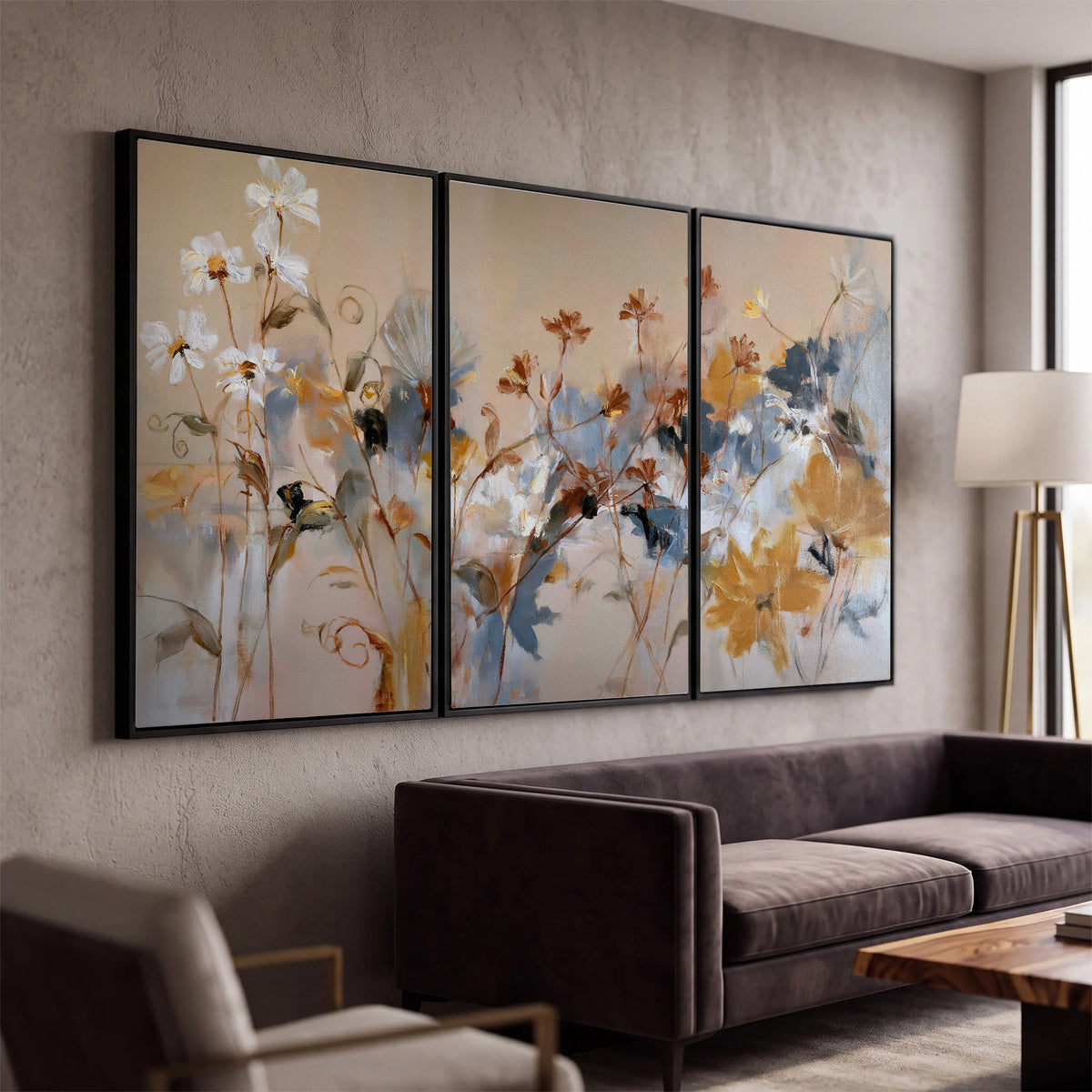 Loose blue and ochre blossoms layered across a warm neutral background 3 piece framed canvas wall art displayed in a modern living room