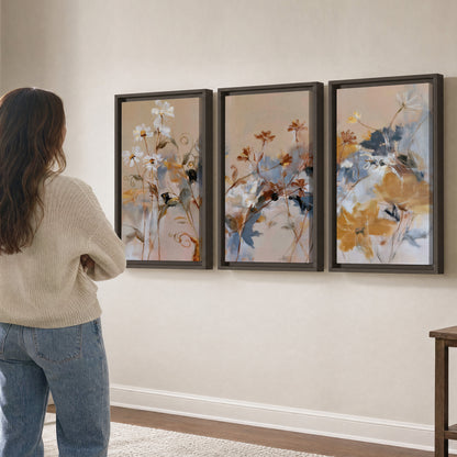 Loose blue and ochre blossoms layered across a warm neutral background 3 piece framed canvas wall art three panel arrangement on a wall