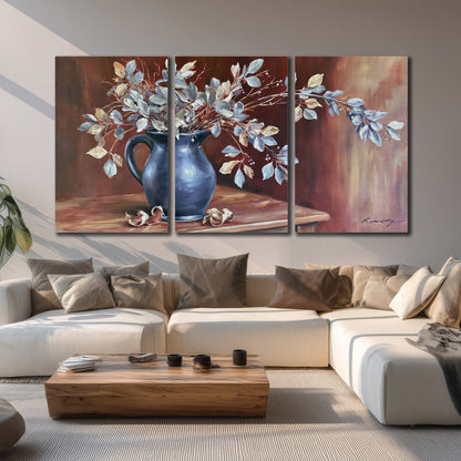 White flowering branches gathered in a deep blue pitcher against a warm rust-colored wall 3 piece canvas wall art displayed in a living room