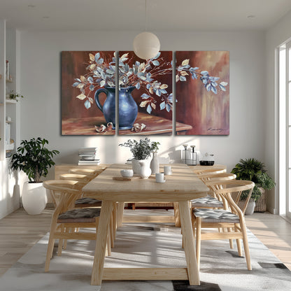 White flowering branches gathered in a deep blue pitcher against a warm rust-colored wall 3 piece canvas wall art room and product view