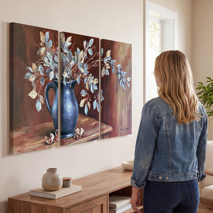White flowering branches gathered in a deep blue pitcher against a warm rust-colored wall 3 piece canvas wall art three panel arrangement on a wall