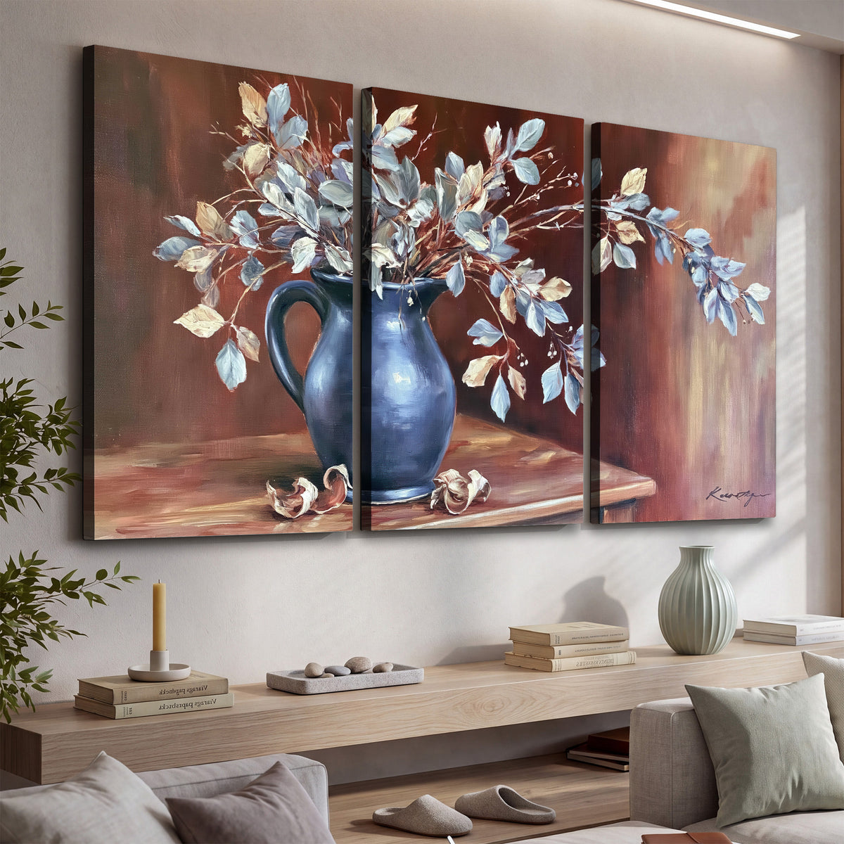 White flowering branches gathered in a deep blue pitcher against a warm rust-colored wall 3 piece canvas wall art displayed in a console