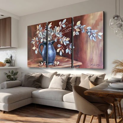 White flowering branches gathered in a deep blue pitcher against a warm rust-colored wall 3 piece canvas wall art room and product view