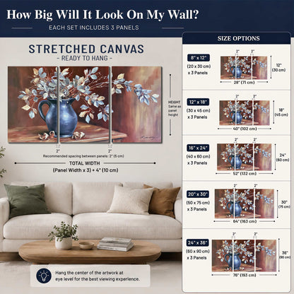 White flowering branches gathered in a deep blue pitcher against a warm rust-colored wall 3 piece canvas wall art size guide above a sofa; room view is illustrative
