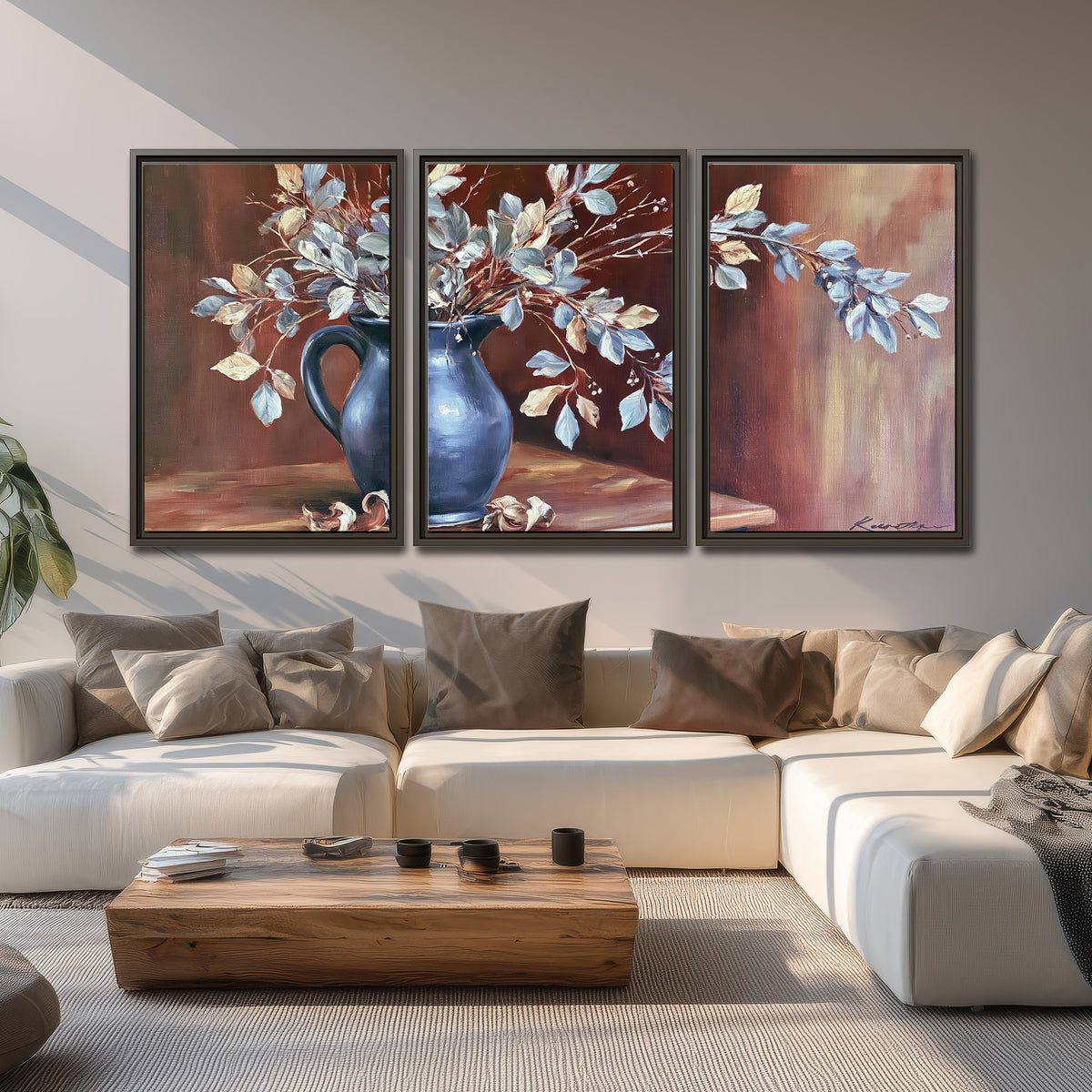 White flowering branches gathered in a deep blue pitcher against a warm rust-colored wall 3 piece framed canvas wall art displayed in a living room