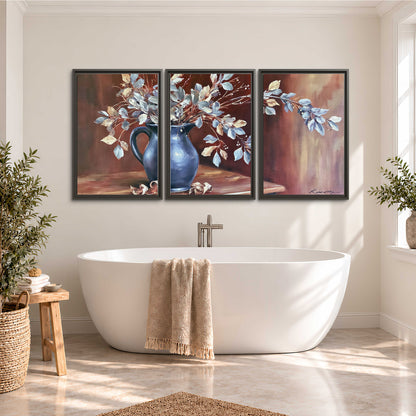 White flowering branches gathered in a deep blue pitcher against a warm rust-colored wall 3 piece framed canvas wall art styled in an interior