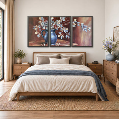 White flowering branches gathered in a deep blue pitcher against a warm rust-colored wall 3 piece framed canvas wall art styled in an interior