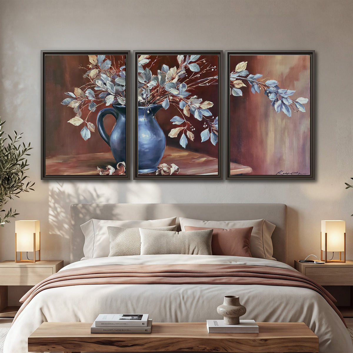 White flowering branches gathered in a deep blue pitcher against a warm rust-colored wall 3 piece framed canvas wall art displayed in a bedroom