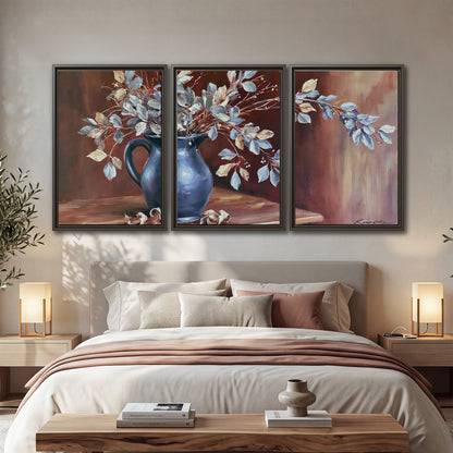 White flowering branches gathered in a deep blue pitcher against a warm rust-colored wall 3 piece framed canvas wall art displayed in a bedroom