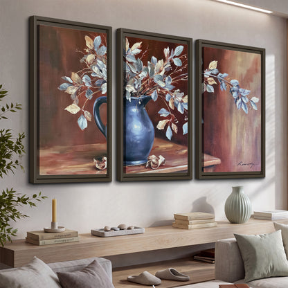 White flowering branches gathered in a deep blue pitcher against a warm rust-colored wall 3 piece framed canvas wall art displayed in a console