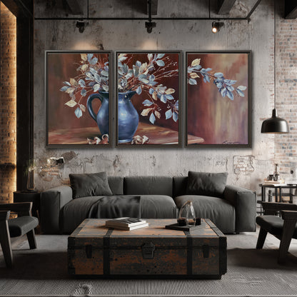 White flowering branches gathered in a deep blue pitcher against a warm rust-colored wall 3 piece framed canvas wall art displayed in a industrial room