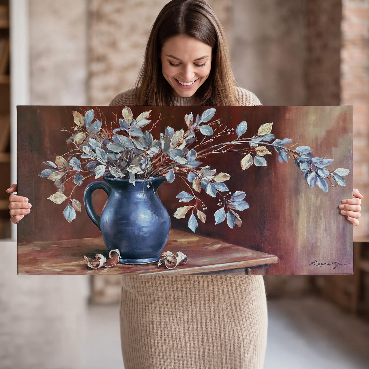 White flowering branches gathered in a deep blue pitcher against a warm rust-colored wall single canvas wall art held in hands